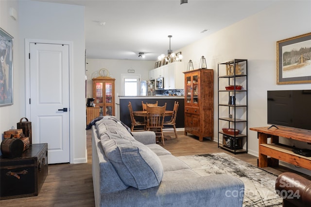 living room with a notable chandelier and hardwood / wood-style flooring