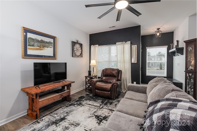 living room with ceiling fan and dark wood-type flooring