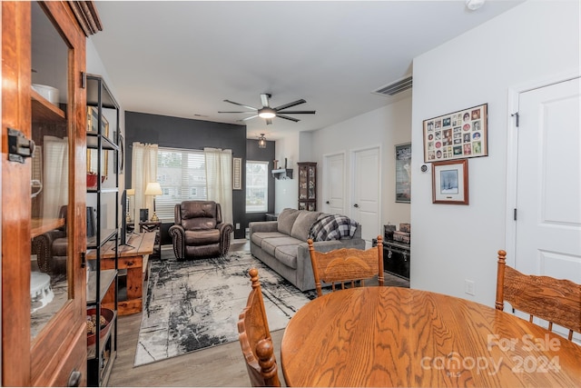 living room with ceiling fan and light hardwood / wood-style flooring