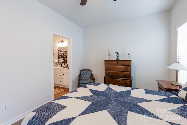 bedroom with hardwood / wood-style floors, ensuite bath, and ceiling fan