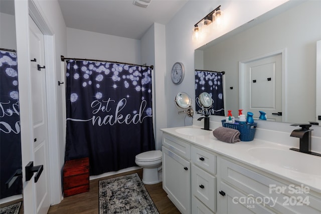 bathroom featuring hardwood / wood-style floors, vanity, and toilet