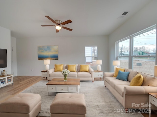 living room with ceiling fan and light hardwood / wood-style flooring