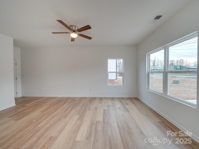 spare room with ceiling fan and light wood-type flooring