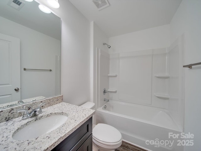 full bathroom featuring toilet, vanity, and  shower combination