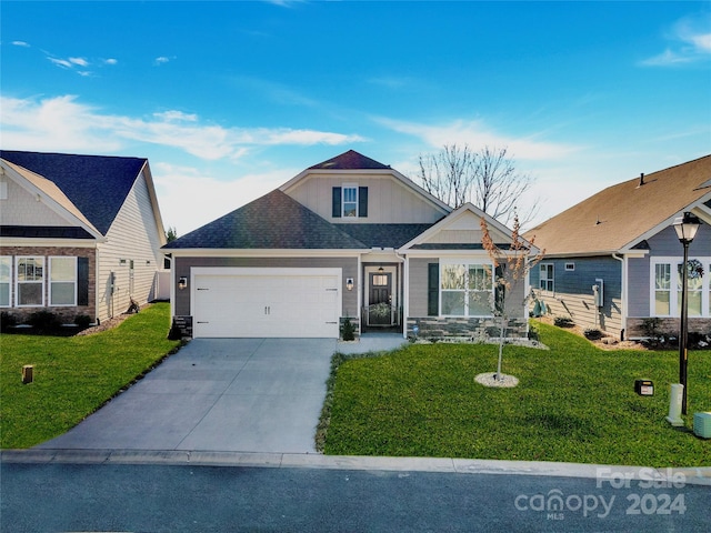 view of front of home featuring a garage and a front lawn