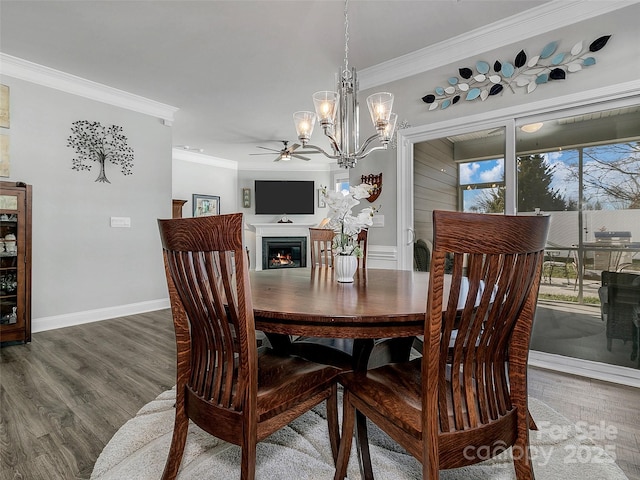 dining room with hardwood / wood-style flooring, crown molding, and a notable chandelier