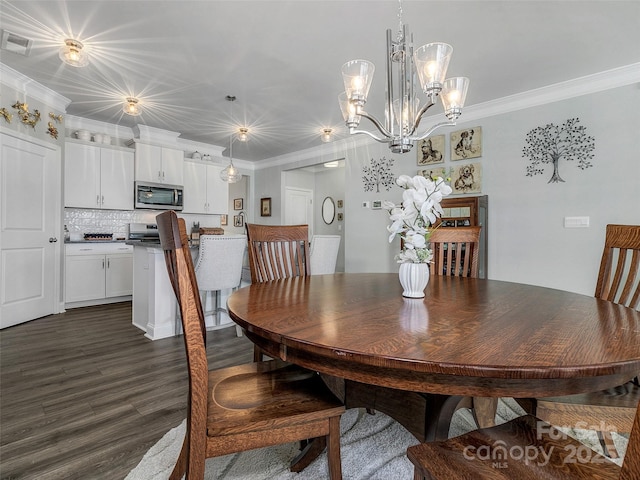 dining area with dark hardwood / wood-style flooring, crown molding, and a chandelier