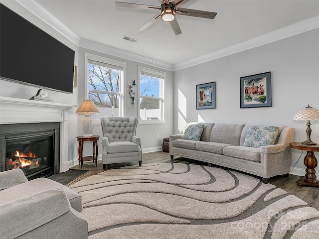 living room featuring crown molding, dark hardwood / wood-style floors, and ceiling fan