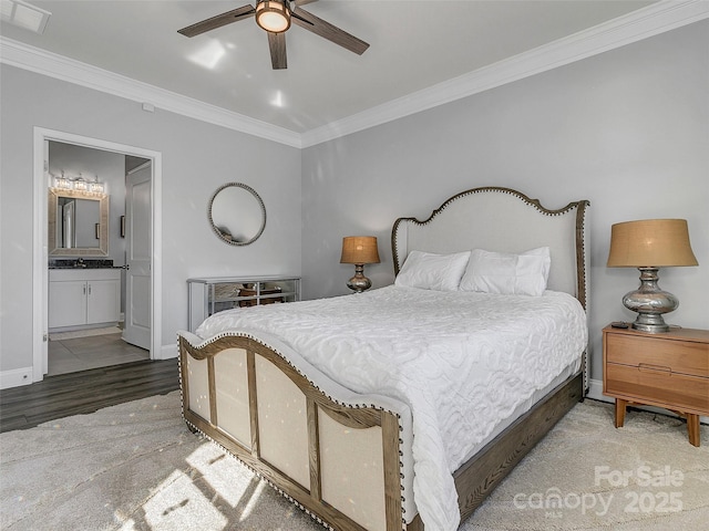 bedroom featuring crown molding, wood-type flooring, ensuite bathroom, and ceiling fan