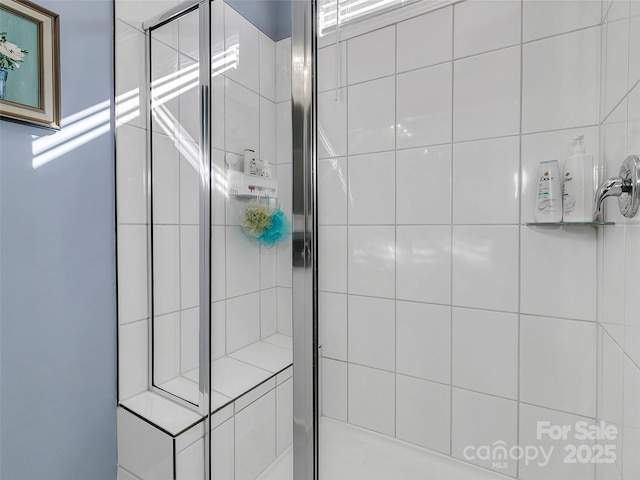 bathroom featuring a shower with door