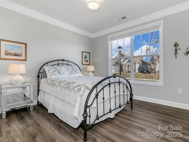 bedroom with crown molding and dark wood-type flooring