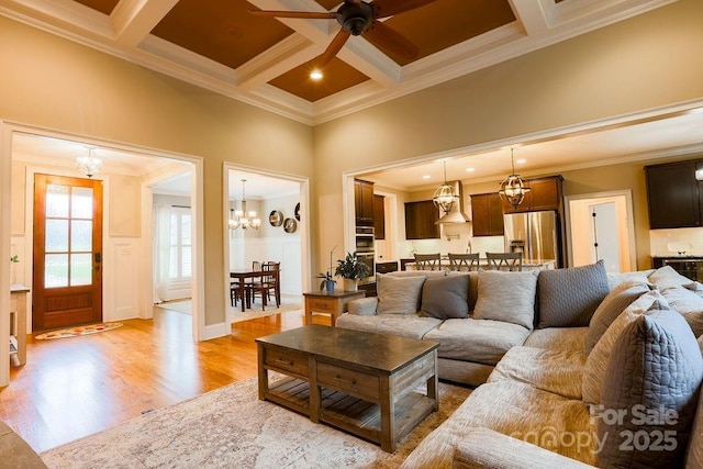 living room featuring beamed ceiling, light wood-type flooring, ornamental molding, and coffered ceiling