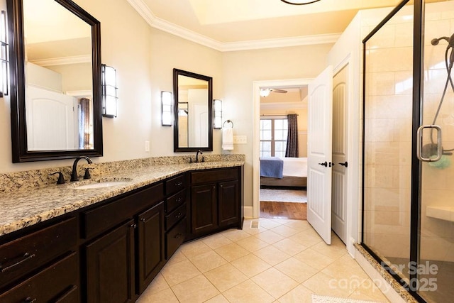 bathroom with tile patterned flooring, ceiling fan, a shower with door, and crown molding