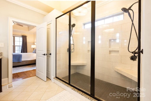 bathroom featuring ornamental molding, tile patterned floors, ceiling fan, and a shower with shower door