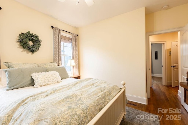 bedroom with ceiling fan and dark hardwood / wood-style flooring