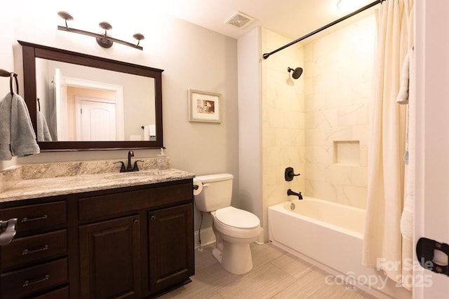 full bathroom featuring vanity, shower / tub combo, and toilet