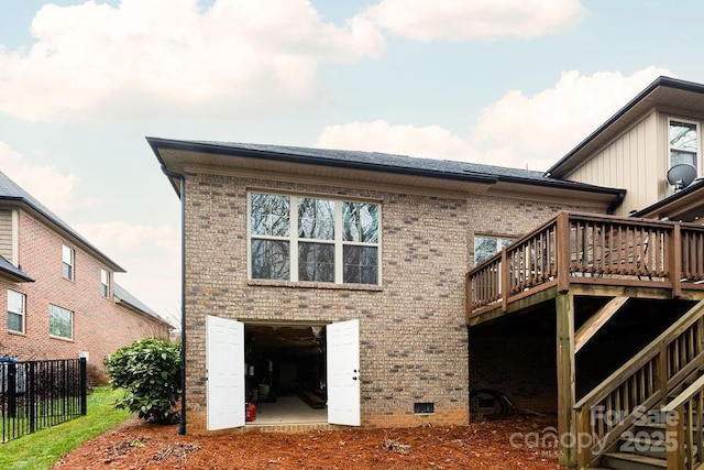 back of house featuring a wooden deck