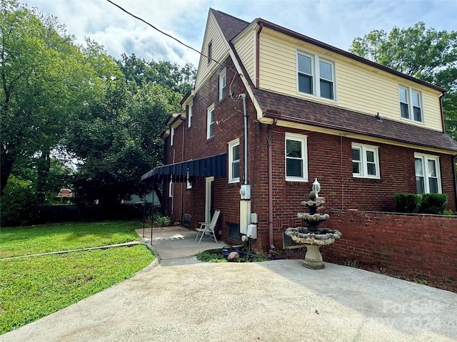 view of front facade with a patio and a front yard