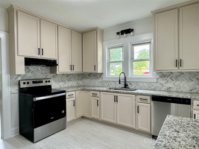 kitchen with cream cabinetry, sink, and appliances with stainless steel finishes