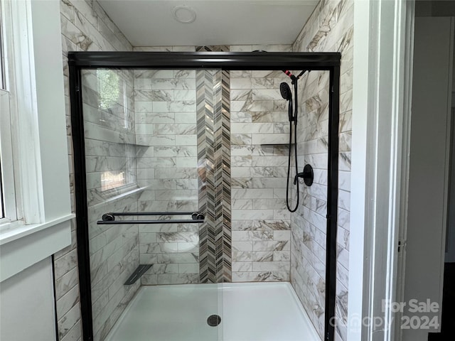 bathroom featuring a shower with shower door