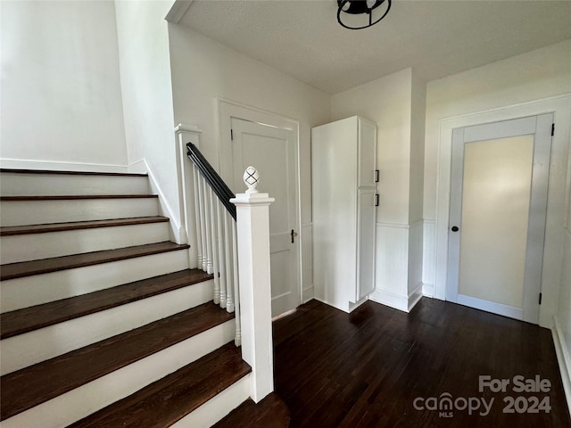 staircase with wood-type flooring