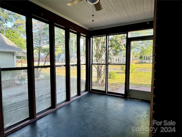 unfurnished sunroom with ceiling fan