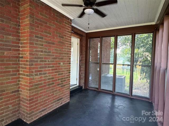 unfurnished sunroom featuring plenty of natural light and ceiling fan