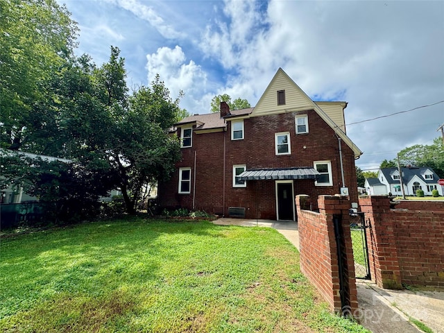 back of property featuring a yard