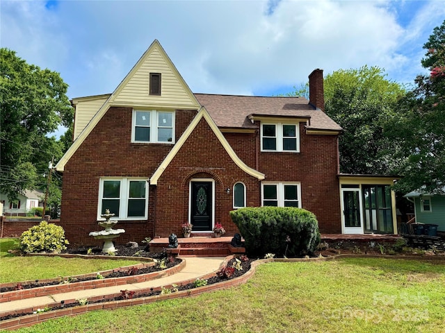 tudor home featuring a front yard