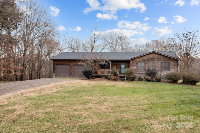 ranch-style house with a front yard and a garage