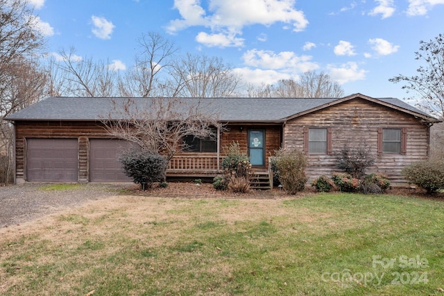 single story home with a garage and a front lawn