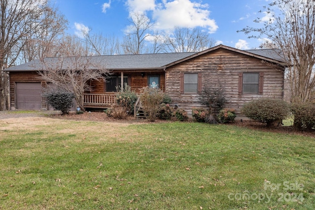 ranch-style home with a garage and a front yard