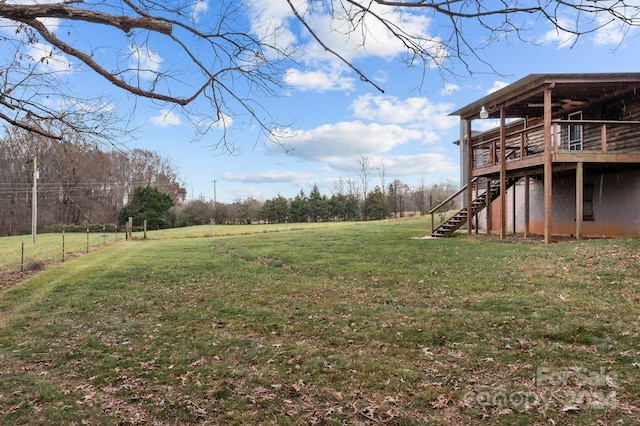 view of yard with a rural view and a deck