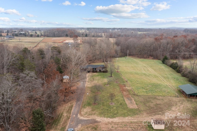 birds eye view of property with a rural view