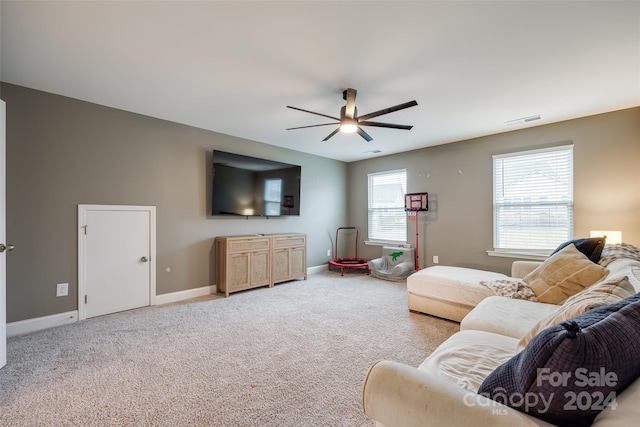 carpeted living room with ceiling fan