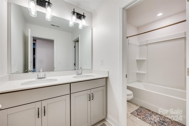 full bathroom with vanity,  shower combination, tile patterned floors, and toilet