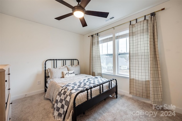 bedroom with light carpet and ceiling fan