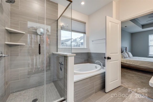 bathroom featuring tile patterned floors and independent shower and bath