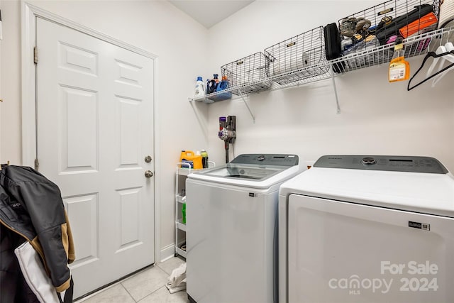 washroom with independent washer and dryer and light tile patterned floors