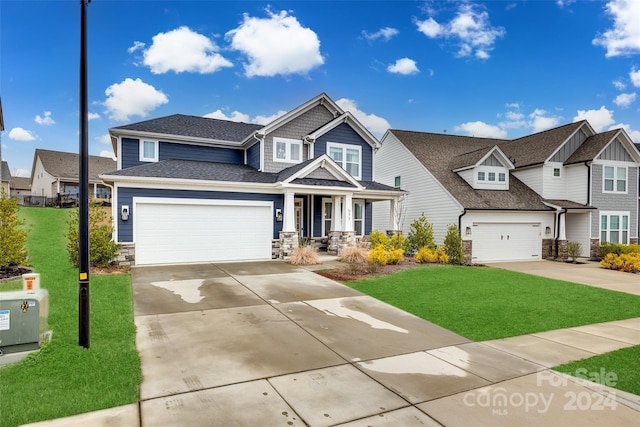 craftsman house with a garage and a front lawn