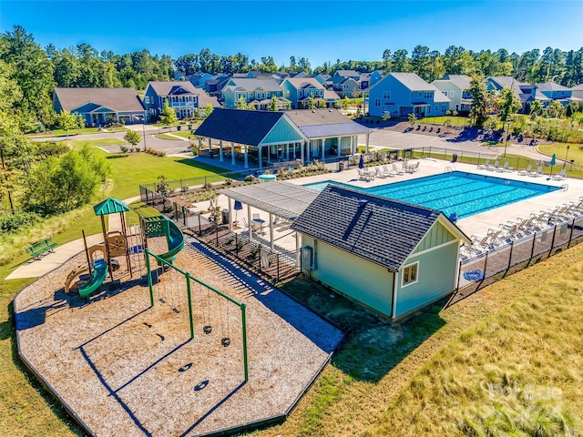 view of pool featuring a patio, a playground, and a lawn