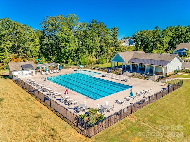 view of pool featuring a yard, an outbuilding, and a patio