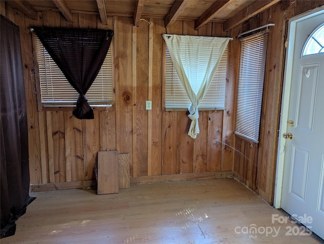 interior space featuring light hardwood / wood-style floors and wood walls