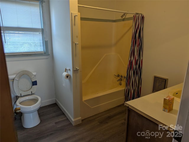 full bathroom featuring wood-type flooring, toilet, shower / bath combo with shower curtain, and vanity