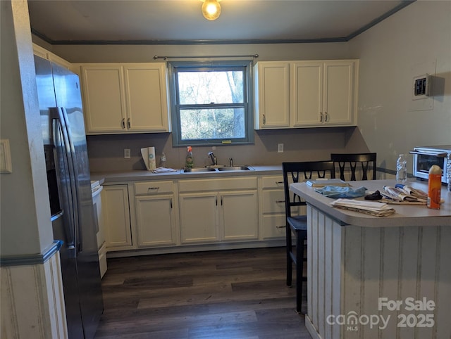 kitchen featuring white cabinetry, sink, electric range, and dark hardwood / wood-style floors