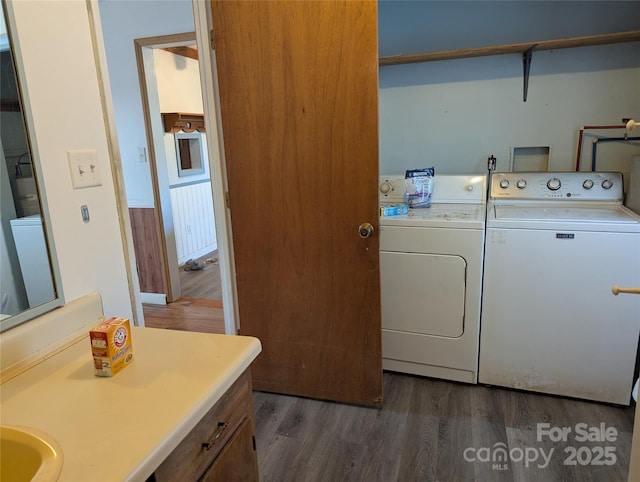 washroom with washing machine and dryer and dark wood-type flooring