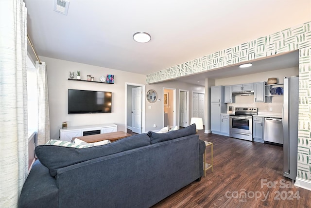 living room featuring dark hardwood / wood-style floors and plenty of natural light