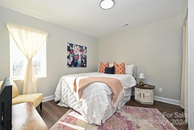 bedroom featuring dark hardwood / wood-style flooring