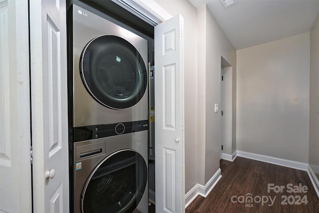 laundry room with stacked washer / dryer and dark hardwood / wood-style flooring