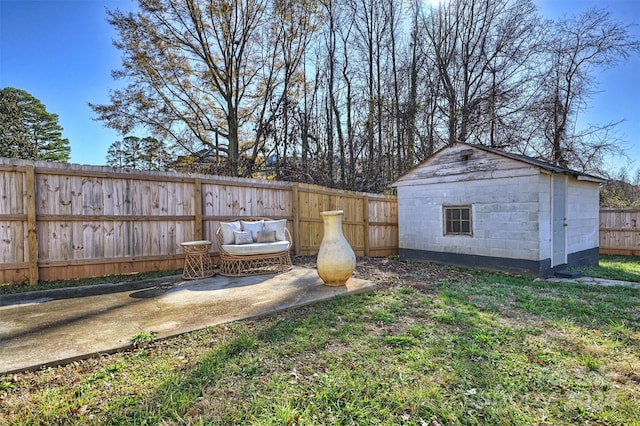 view of yard featuring a storage shed and a patio